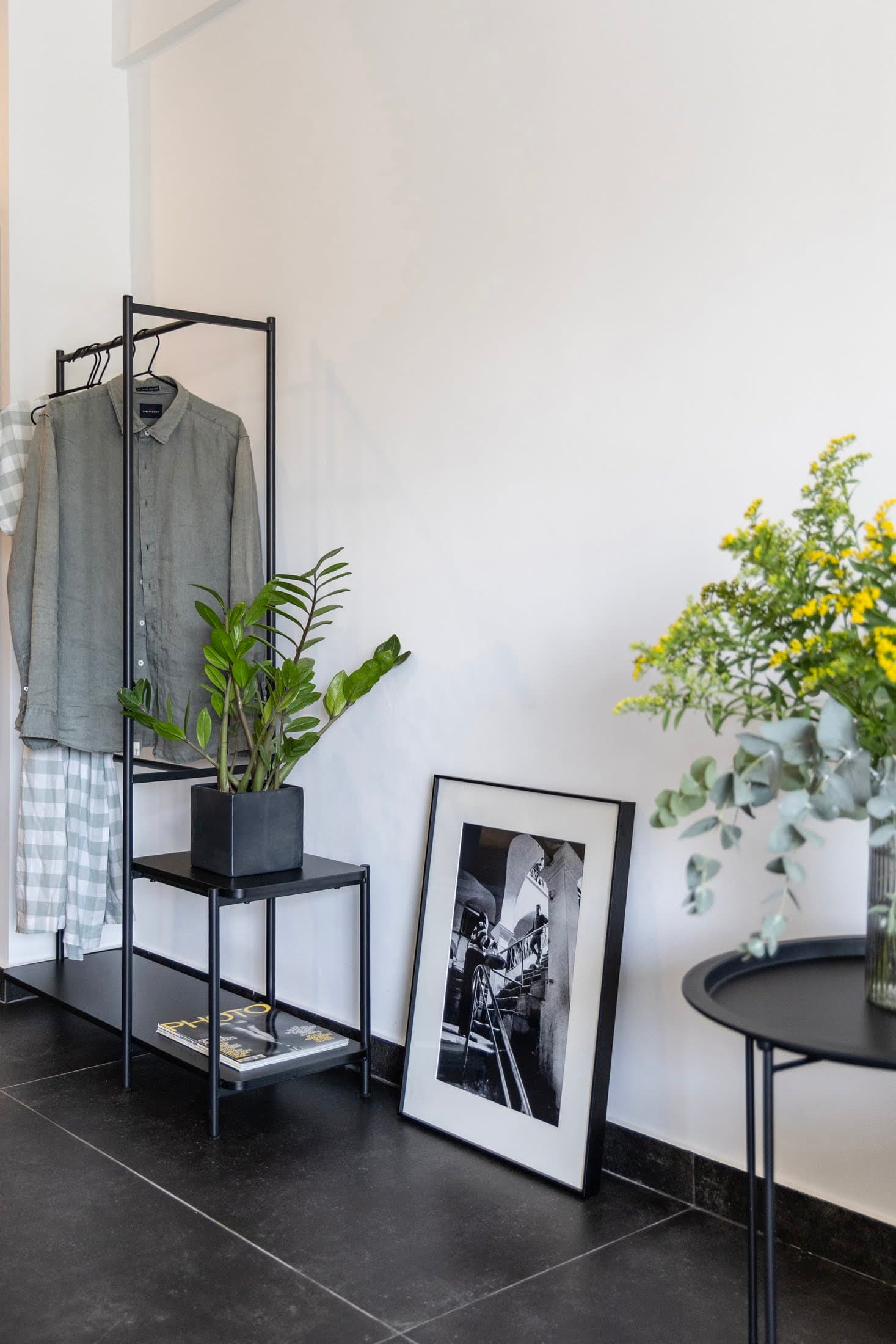 Minimalist entryway area with open wardrobe rack